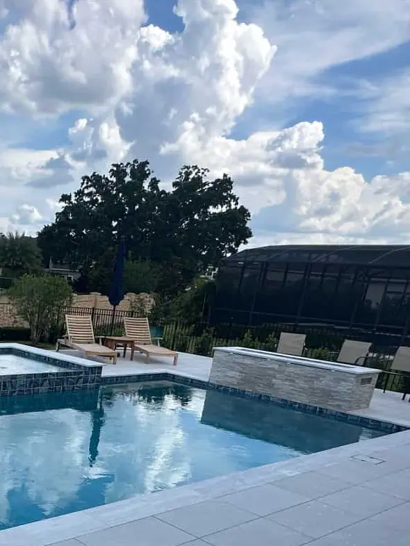 Palm-lined pool by Grunit — Windermere