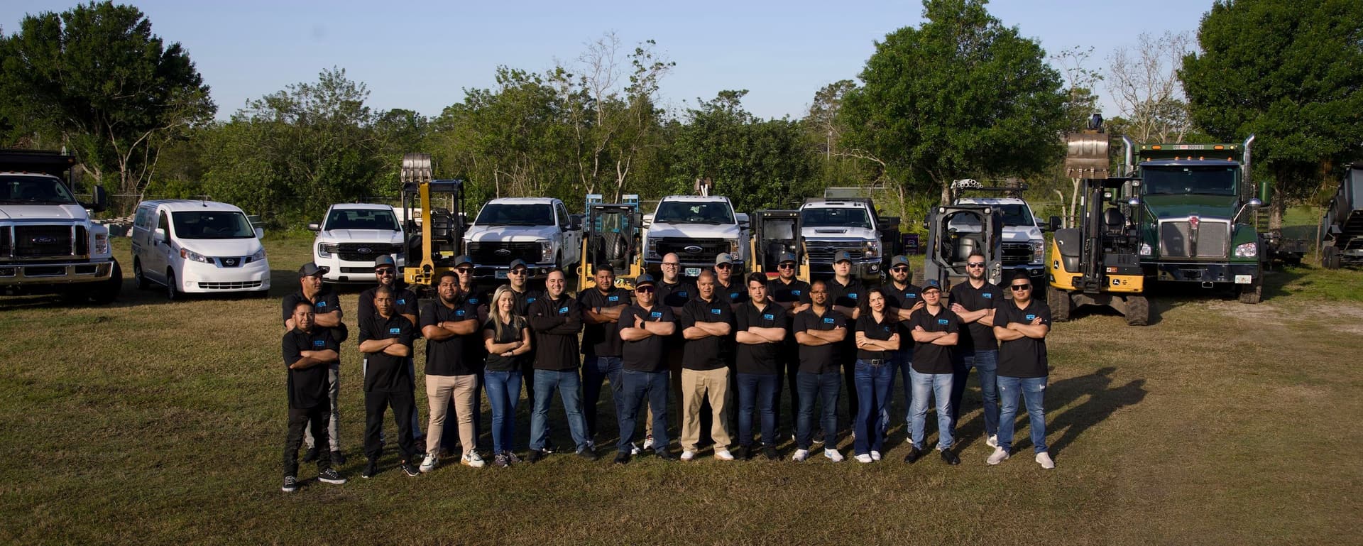 The full Grunit Pool Contractors team in front of their fleet