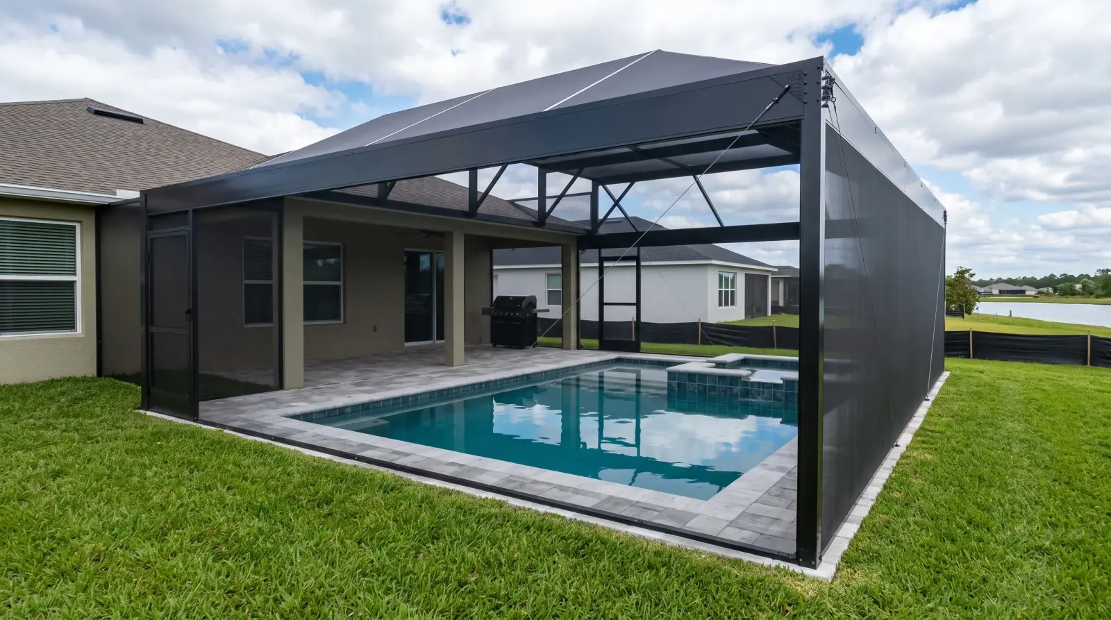 Exterior three-quarter view of the completed screened Sanctuary Drive Residence pool and spa